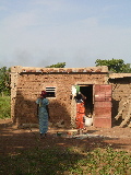 Two women in front of a house