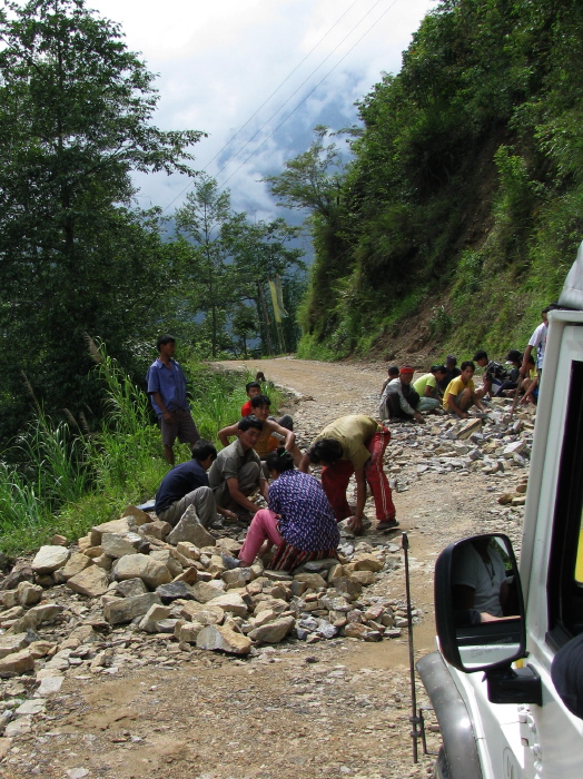 Stone breakers maitaining the road