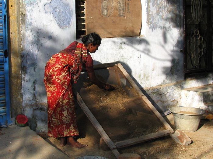 Indienne travaillant avec un tamis