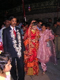 The groom & the bride leaving the party room